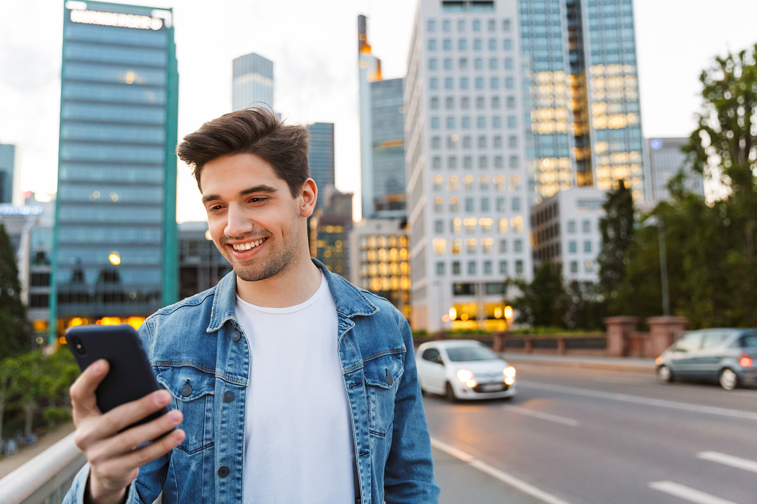 Man using phone in city at night